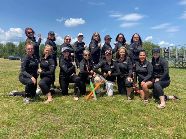 Tina Young and the rest of the Twisted Electric team + friends on a lawn in two rows. 16 ladies total for a charity event.